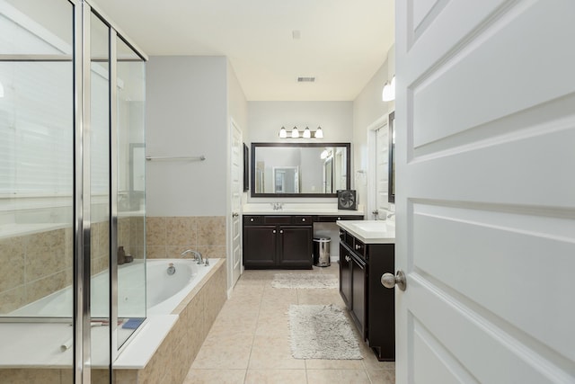 bathroom with tile patterned floors, plus walk in shower, and vanity