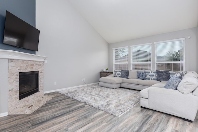 living room with hardwood / wood-style flooring and high vaulted ceiling