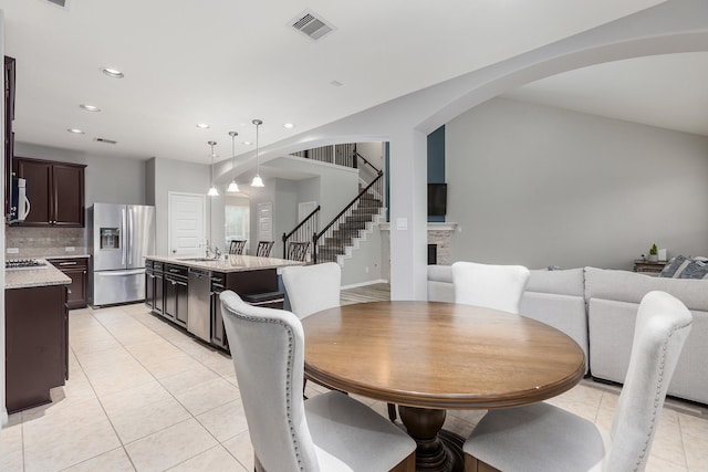 dining room featuring sink and light tile patterned flooring