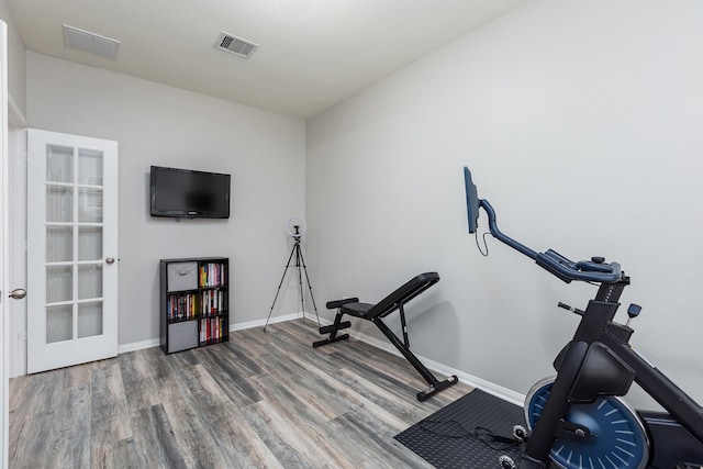 workout room featuring hardwood / wood-style floors