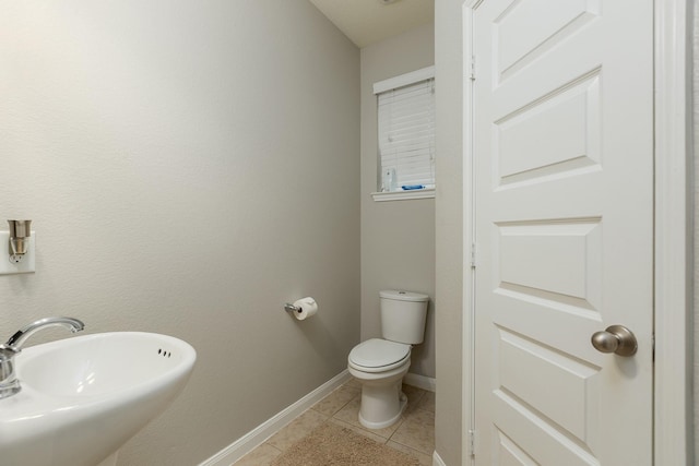 bathroom with sink, tile patterned floors, and toilet