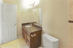 bathroom with vanity, tile patterned floors, and toilet