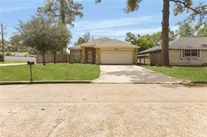 ranch-style house with a garage and a front yard