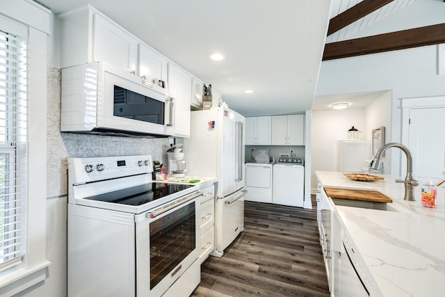 kitchen with white cabinetry, washer and clothes dryer, plenty of natural light, and white appliances