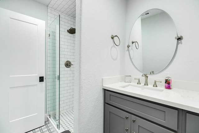 bathroom with vanity and a shower with shower door