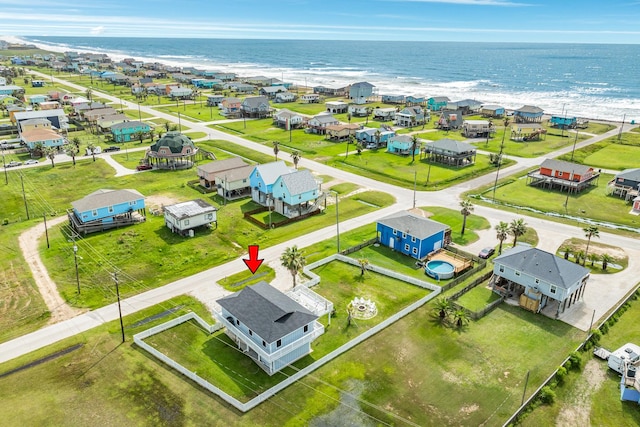 birds eye view of property featuring a view of the beach and a water view