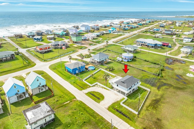 birds eye view of property with a beach view and a water view