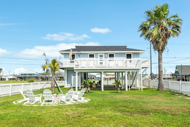 rear view of property with a wooden deck and a lawn