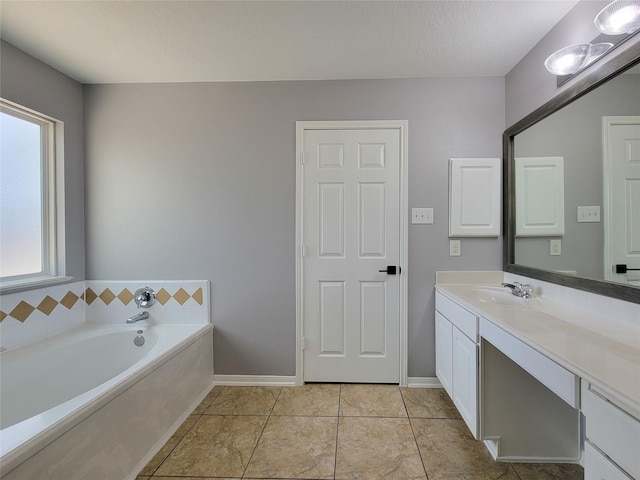 bathroom with vanity, tile patterned floors, a textured ceiling, and a tub to relax in