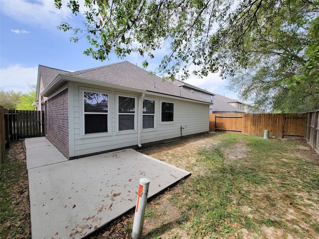 back of house with a yard and a patio area