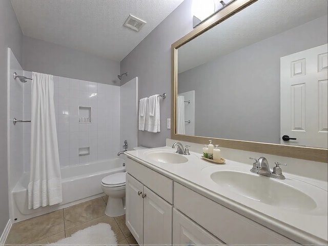 full bathroom featuring tile patterned floors, toilet, a textured ceiling, vanity, and shower / bath combination with curtain