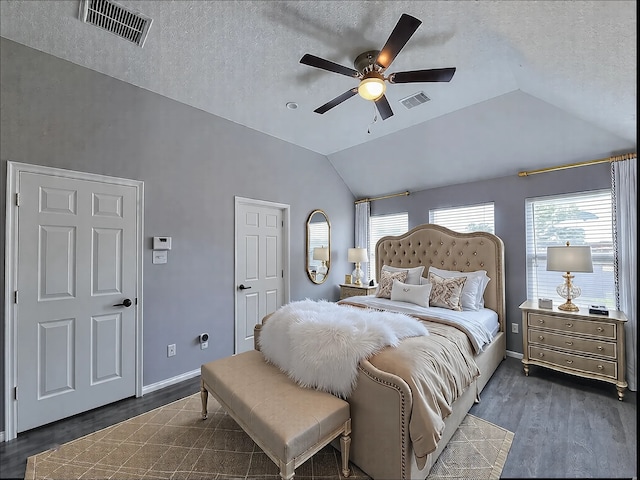 bedroom with lofted ceiling, ceiling fan, dark hardwood / wood-style flooring, and a textured ceiling