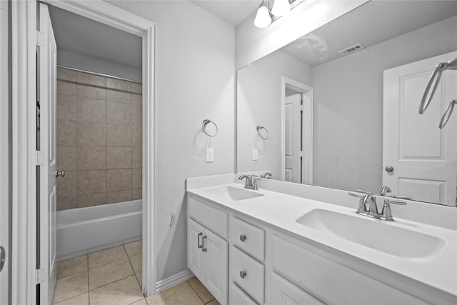 bathroom with tile patterned flooring, vanity, and tiled shower / bath combo