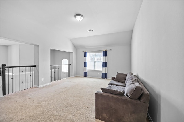 living area with vaulted ceiling and carpet flooring