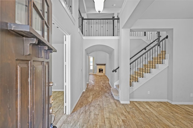 foyer entrance with hardwood / wood-style flooring and a high ceiling