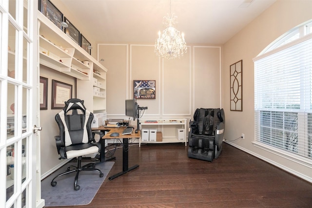 home office featuring dark wood-type flooring, a healthy amount of sunlight, and an inviting chandelier