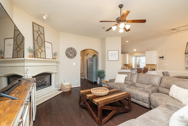 living room with dark hardwood / wood-style flooring and ceiling fan