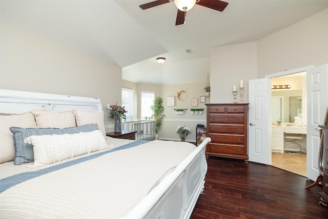 bedroom featuring ceiling fan, lofted ceiling, dark hardwood / wood-style flooring, and connected bathroom