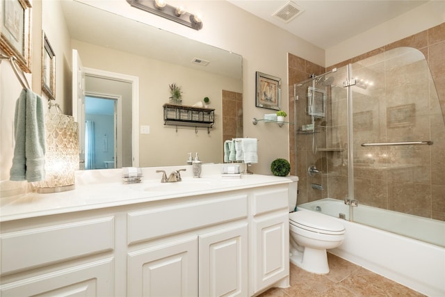 full bathroom featuring toilet, vanity, and shower / bath combination with glass door