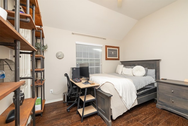 bedroom with lofted ceiling and dark hardwood / wood-style floors