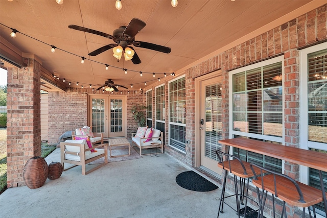 view of patio with ceiling fan and an outdoor living space