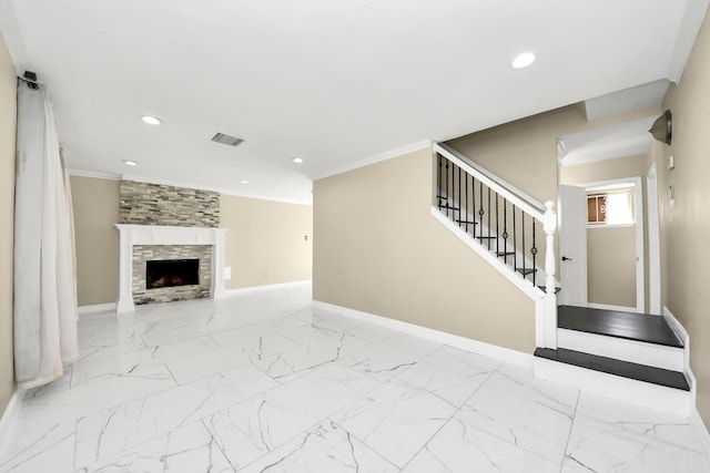 unfurnished living room featuring crown molding and a tiled fireplace