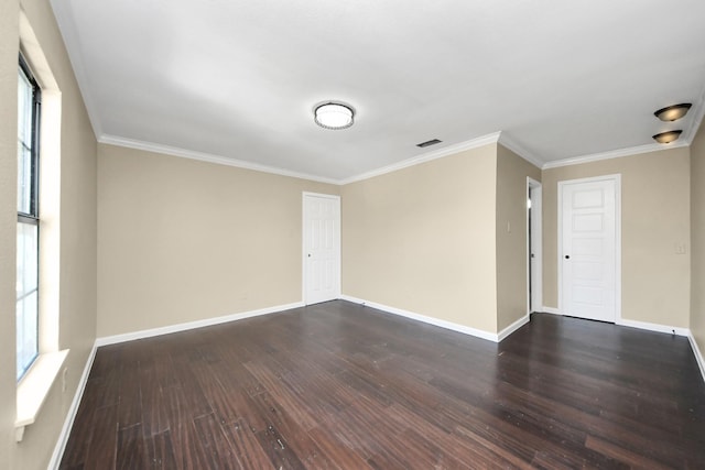 empty room with dark wood-type flooring and ornamental molding