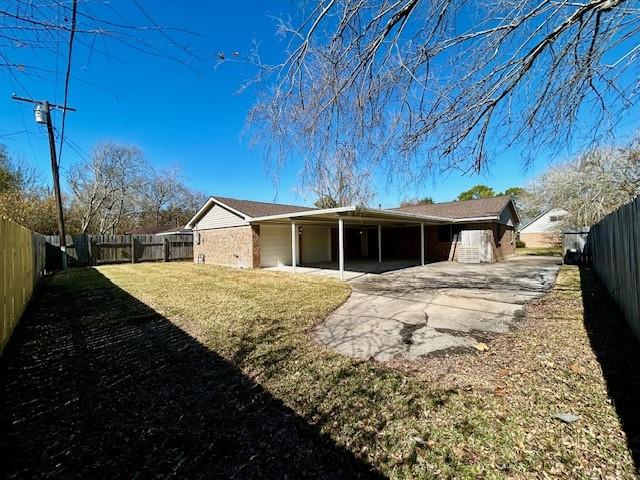 rear view of property with a lawn