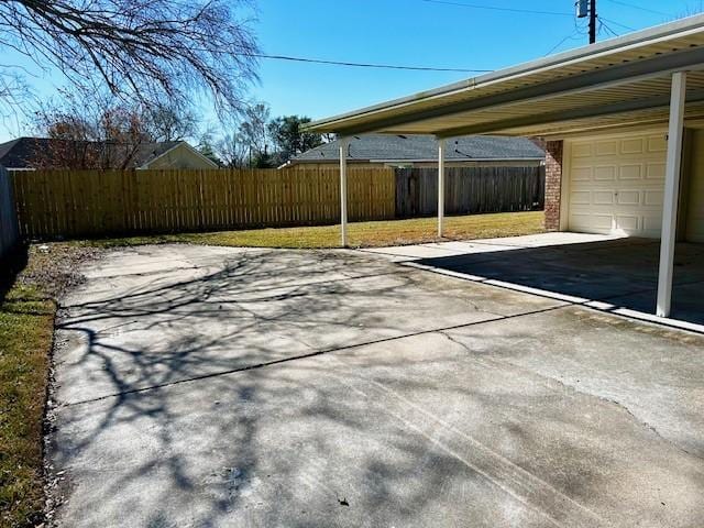 view of car parking featuring a garage and a carport