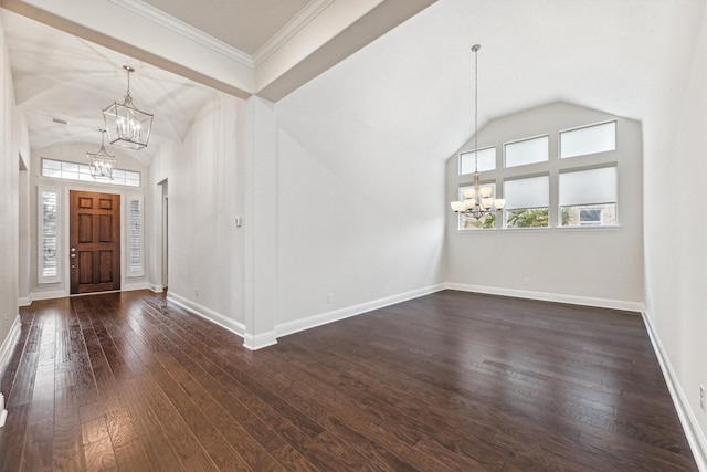 entrance foyer with dark hardwood / wood-style flooring, vaulted ceiling, ornamental molding, and an inviting chandelier