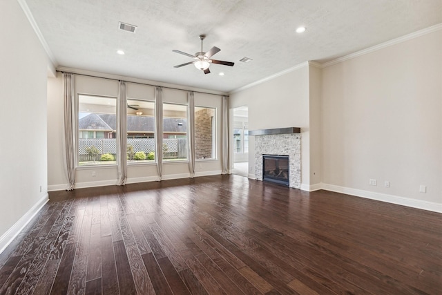 unfurnished living room featuring a fireplace, ornamental molding, dark hardwood / wood-style floors, and ceiling fan