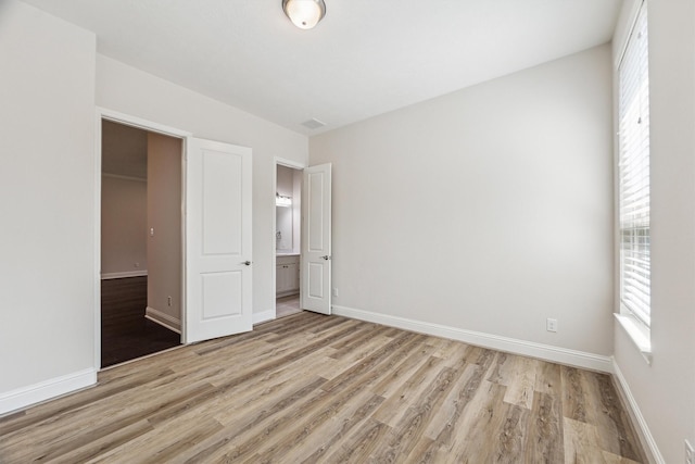 unfurnished bedroom with light wood-type flooring