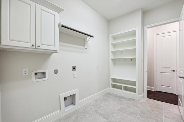 laundry area with gas dryer hookup, cabinets, washer hookup, hookup for an electric dryer, and built in shelves