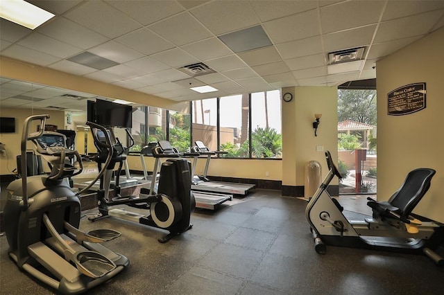 exercise room featuring a paneled ceiling