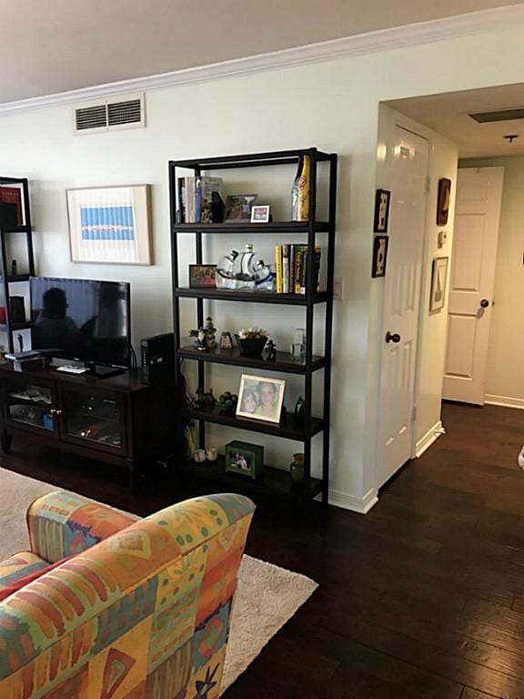 living room with crown molding and dark hardwood / wood-style flooring