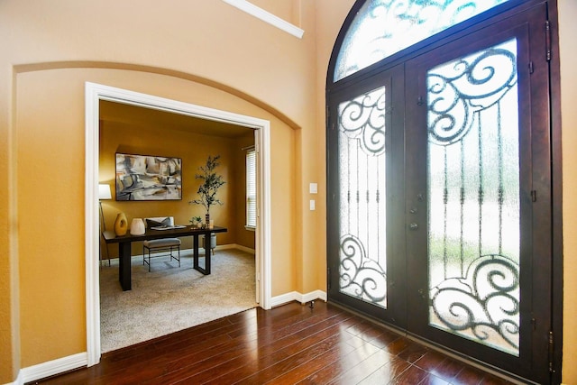 foyer entrance with dark hardwood / wood-style floors and french doors