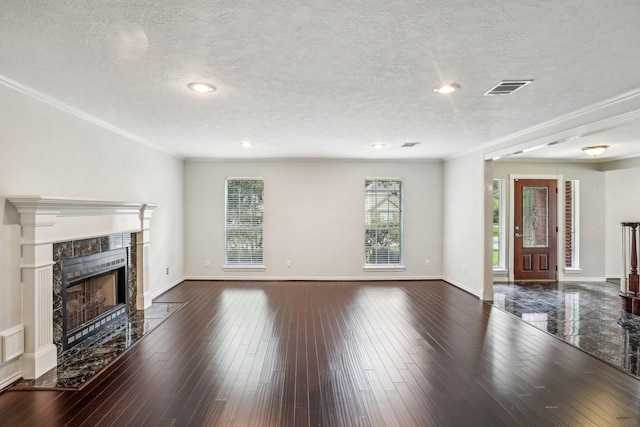 unfurnished living room with ornamental molding, a premium fireplace, dark hardwood / wood-style flooring, and a textured ceiling