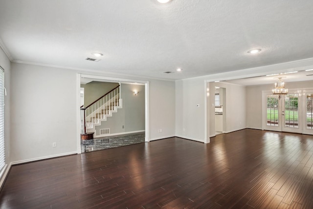 unfurnished room with dark hardwood / wood-style flooring, crown molding, french doors, and a textured ceiling