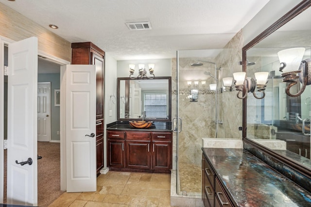 bathroom featuring vanity, a shower with shower door, a textured ceiling, and an inviting chandelier