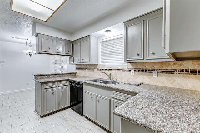 kitchen featuring dishwasher, sink, hanging light fixtures, and gray cabinetry