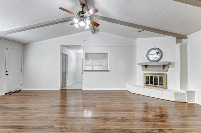 unfurnished living room featuring dark hardwood / wood-style floors, a textured ceiling, and a fireplace