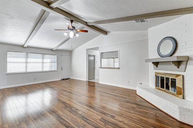 unfurnished living room featuring hardwood / wood-style flooring, a fireplace, and a textured ceiling