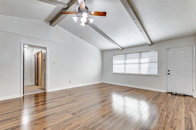 unfurnished living room with wood-type flooring, lofted ceiling with beams, and a textured ceiling