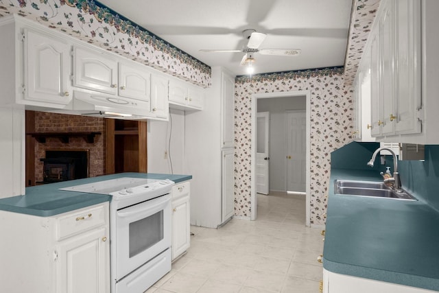 kitchen featuring sink, light tile patterned floors, ceiling fan, white range with electric cooktop, and white cabinets