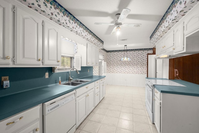 kitchen with pendant lighting, sink, white appliances, ceiling fan, and white cabinets