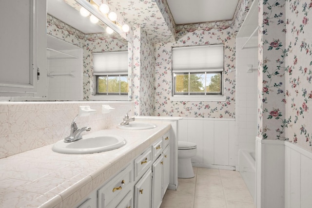 bathroom featuring tile patterned flooring, vanity, plenty of natural light, and toilet