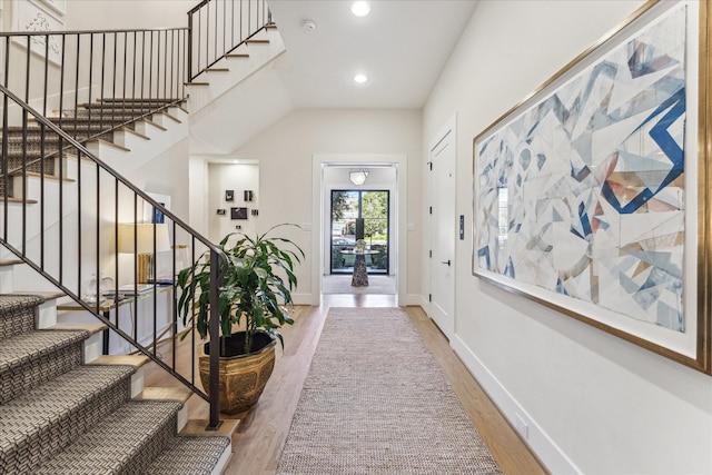 foyer with hardwood / wood-style flooring and a high ceiling