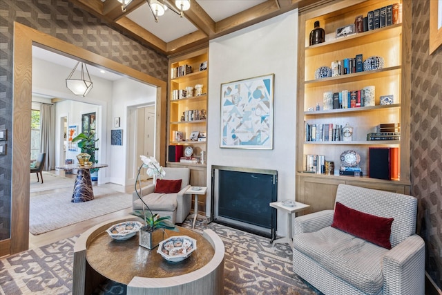 living area featuring coffered ceiling, beam ceiling, and built in features