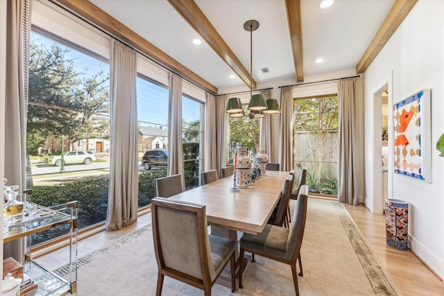 sunroom / solarium with a notable chandelier and beam ceiling