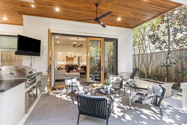 view of patio featuring an outdoor living space, exterior kitchen, a grill, and ceiling fan